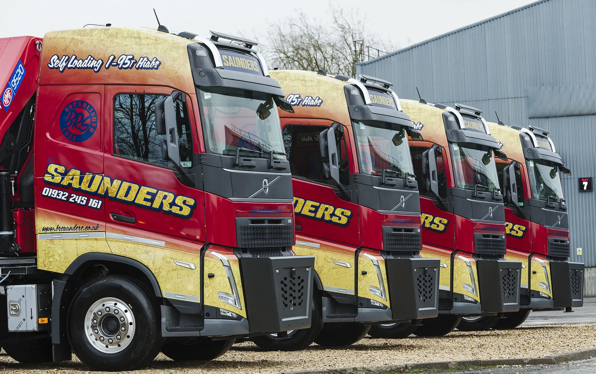 A row of red and yellow trucks parked next to each other.