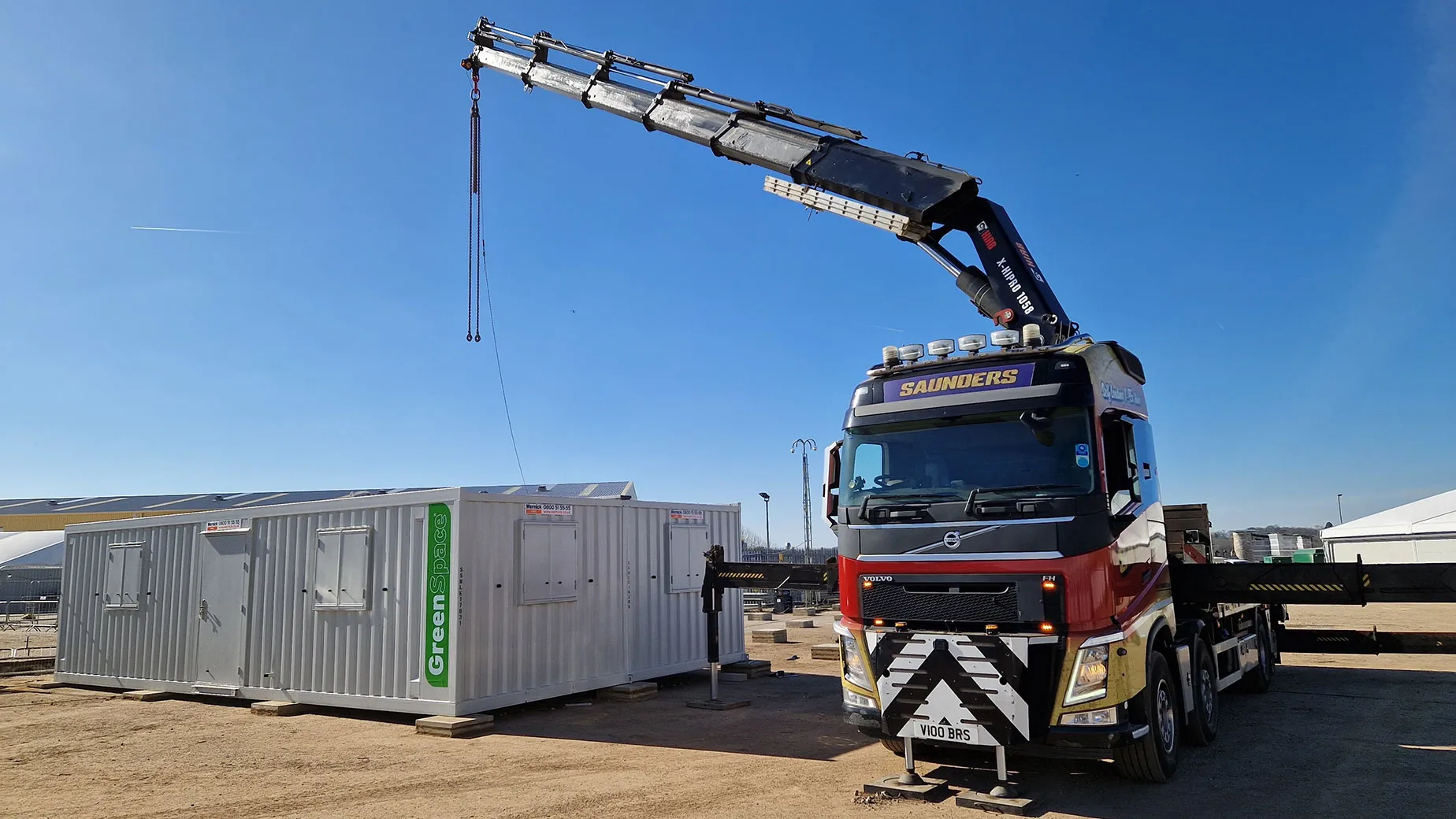 A crane is attached to the back of a truck.